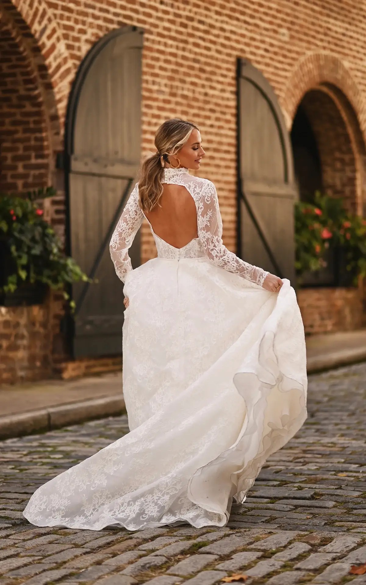 back of a model in long sleeved bridal gown